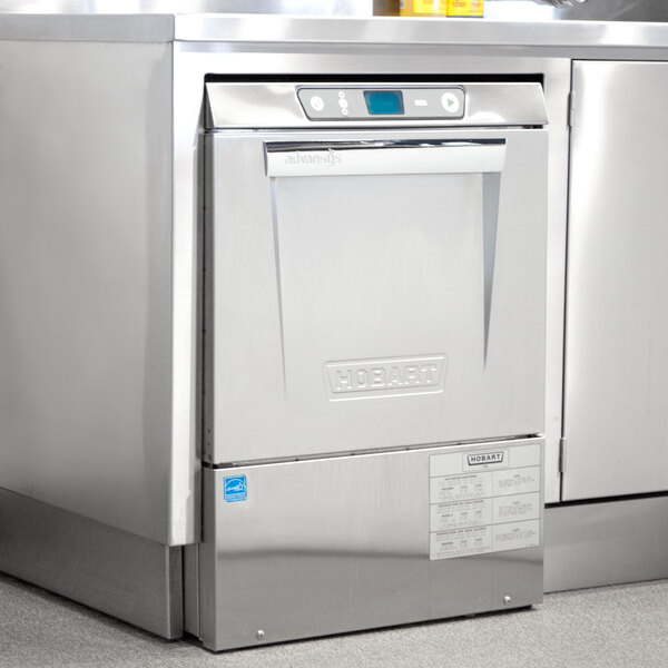 A stainless steel Hobart LXeR-6 Advansys undercounter dishwasher with a blue screen.