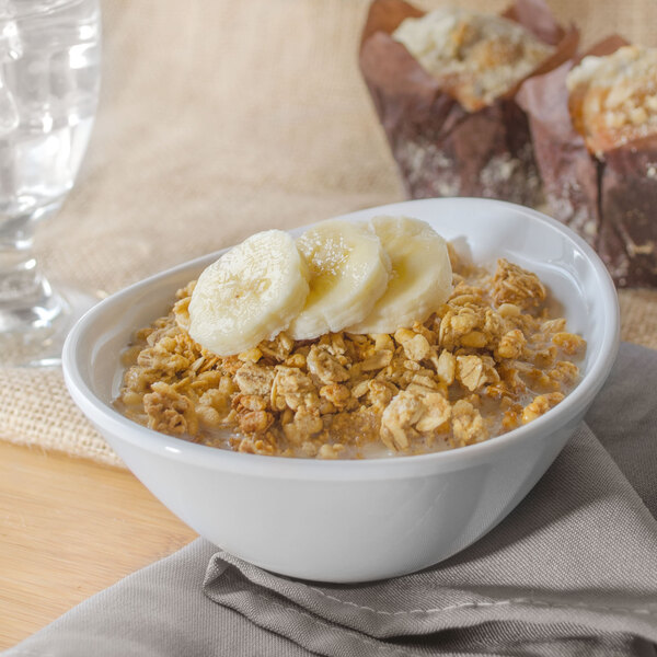 A close-up of a Magnolia melamine bowl with oatmeal, bananas, and muffins.