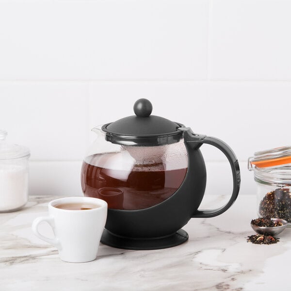 A Choice tempered glass tea pot with a cup of tea.