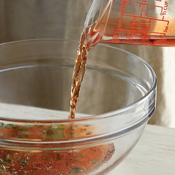 A close up of Admiration Red Italian Style Vinegar being poured into a bowl.