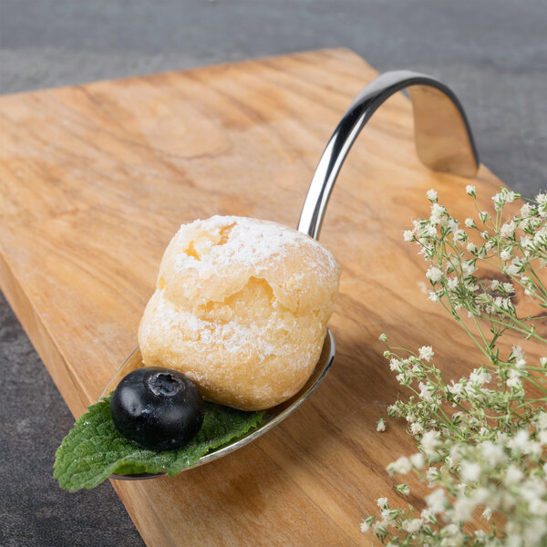 A Bon Chef stainless steel tasting spoon with dessert on it.