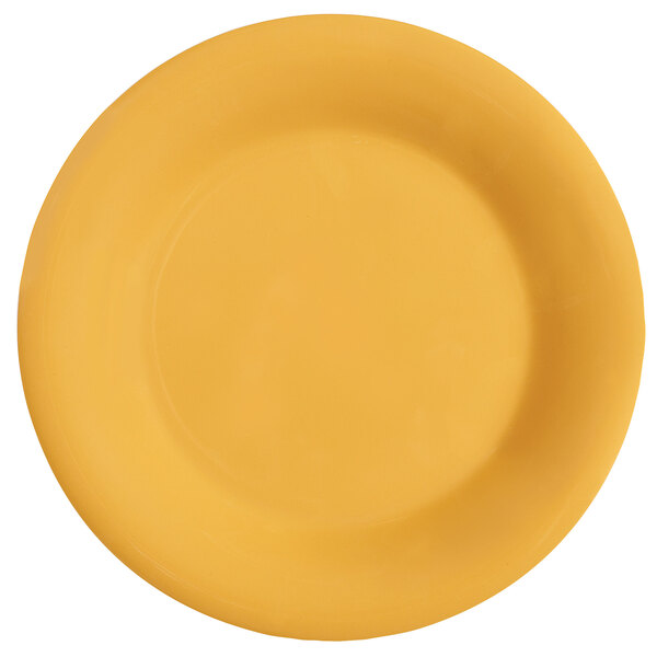 A close up of a GET Tropical Yellow wide rim melamine plate with a white background.