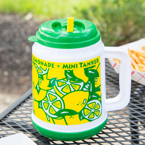 A green and yellow plastic Mini Tanker lemonade mug with a straw and lid.