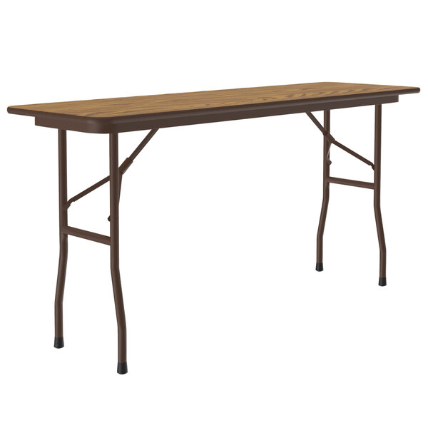 A Correll medium oak rectangular folding table with legs.
