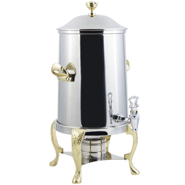 A stainless steel coffee chafer urn with brass trim.