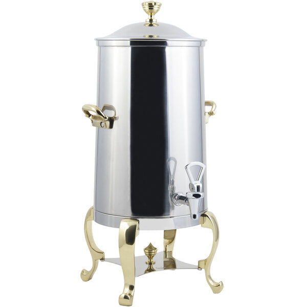 A stainless steel coffee chafer urn with brass trim.