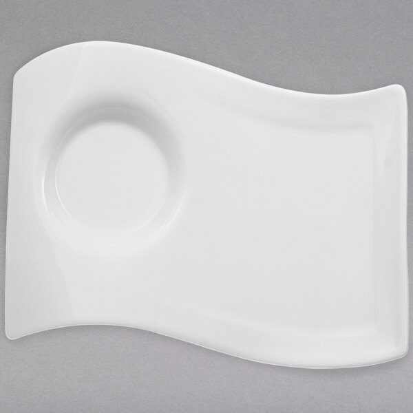 A white Villeroy & Boch porcelain plate with a curved edge.