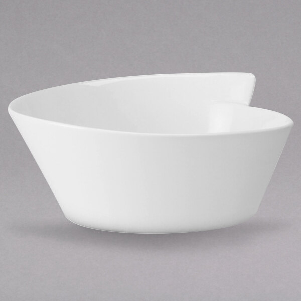 A white Villeroy & Boch salad bowl on a gray surface.