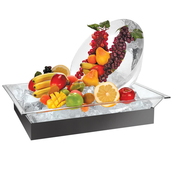 A Cal-Mil ice housing system with a glass bowl filled with fruit and ice.