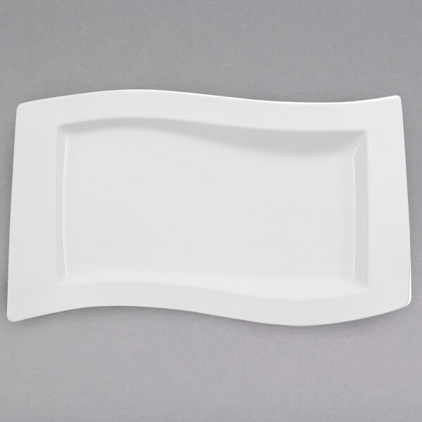 A Villeroy & Boch white porcelain platter with a curved edge.
