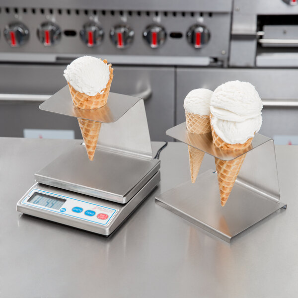 Two ice cream cones on a Cardinal Detecto portion scale.