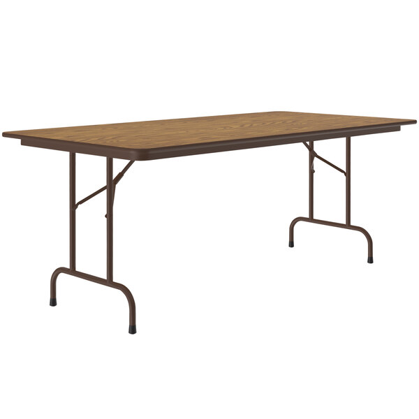 A rectangular Correll medium oak folding table with metal legs.