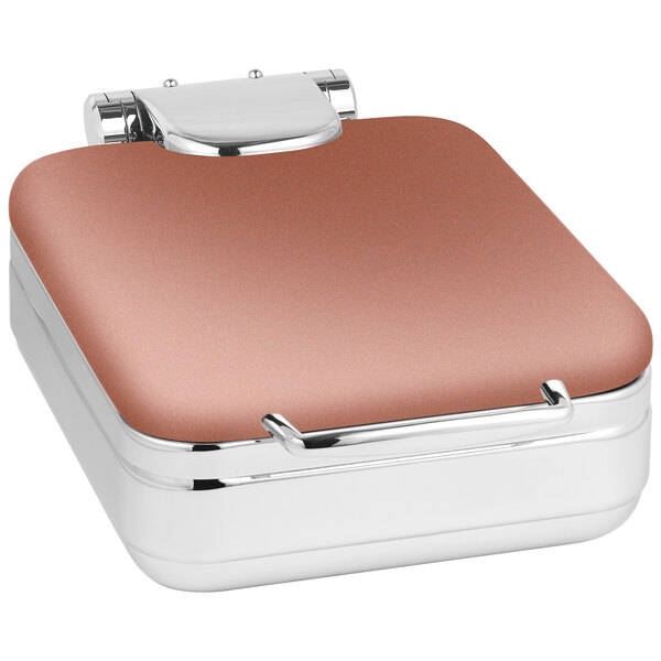 A small square metal chafer with a copper lid and silver handle.