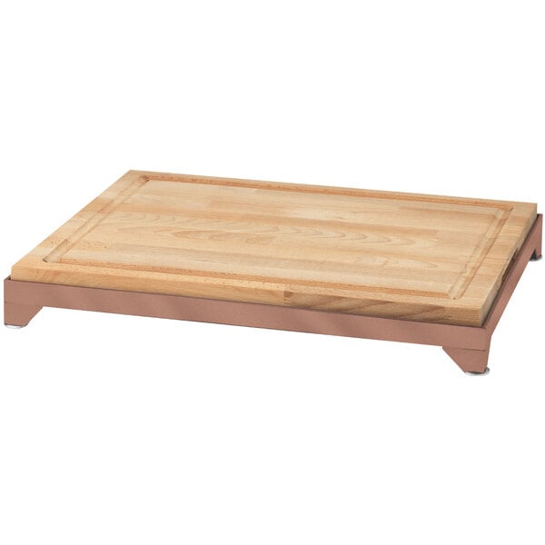 An Eastern Tabletop butcher block carving board with a copper metal frame.