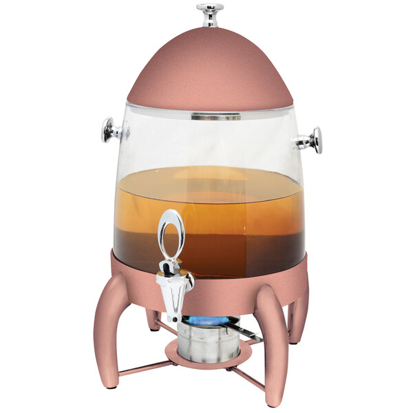 A copper coated stainless steel Eastern Tabletop coffee chafer urn with a brown liquid in it on a metal stand.