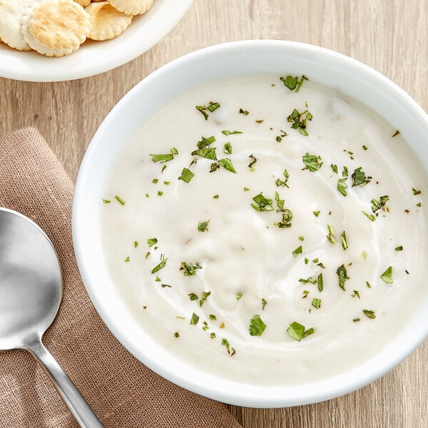 A bowl of Campbell's Cream of Mushroom soup with a silver spoon.