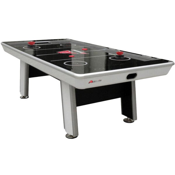 An Atomic Avenger air hockey table with black and white details.
