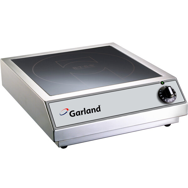 A Garland countertop induction range on a counter.