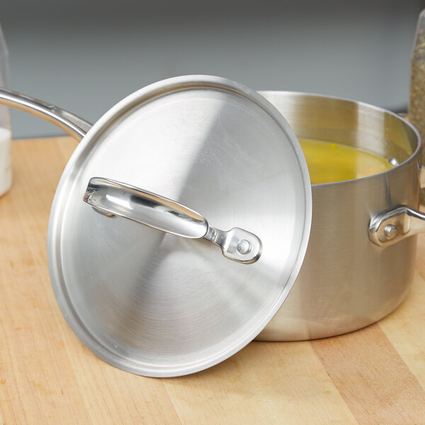 A Vollrath stainless steel pot with a lid on it.