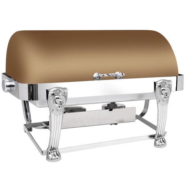 An Eastern Tabletop rectangular bronze coated stainless steel roll top chafer with lion head accents on a table outdoors.