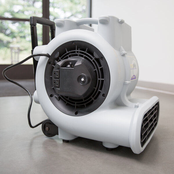 A white ProTeam air blower on the floor.