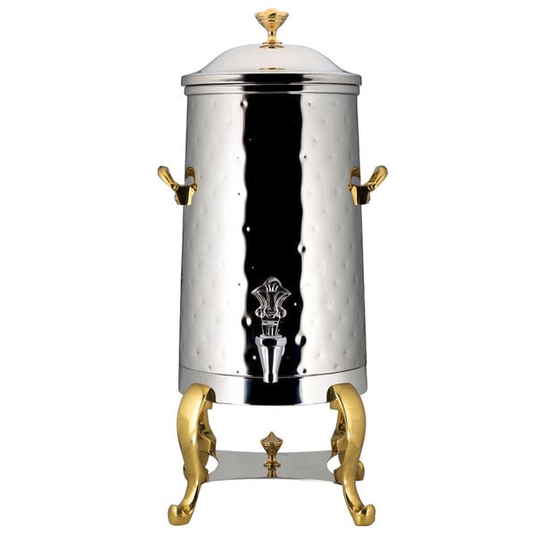 A silver stainless steel coffee chafer urn with brass trim.