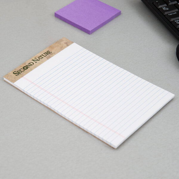 A white TOPS narrow ruled legal pad on a white surface with lined paper on it.