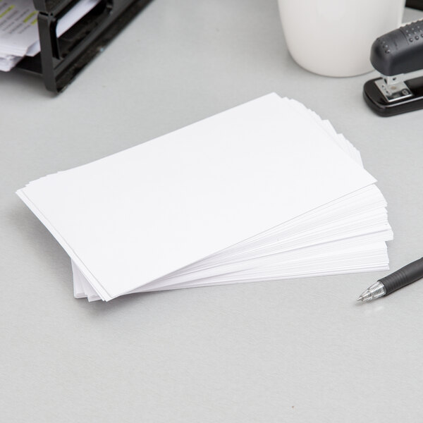 A stack of white Oxford unruled index cards.