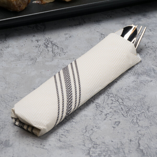 A white FashnPoint napkin with silverware inside.