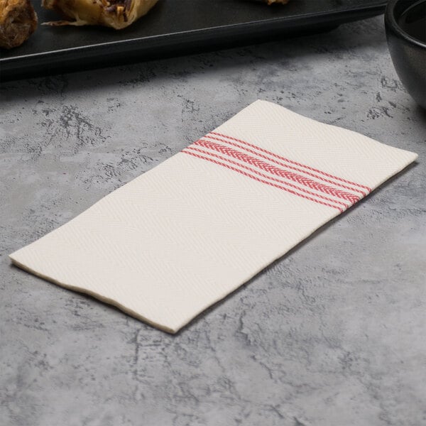 A white napkin with red dishtowel print stripes.