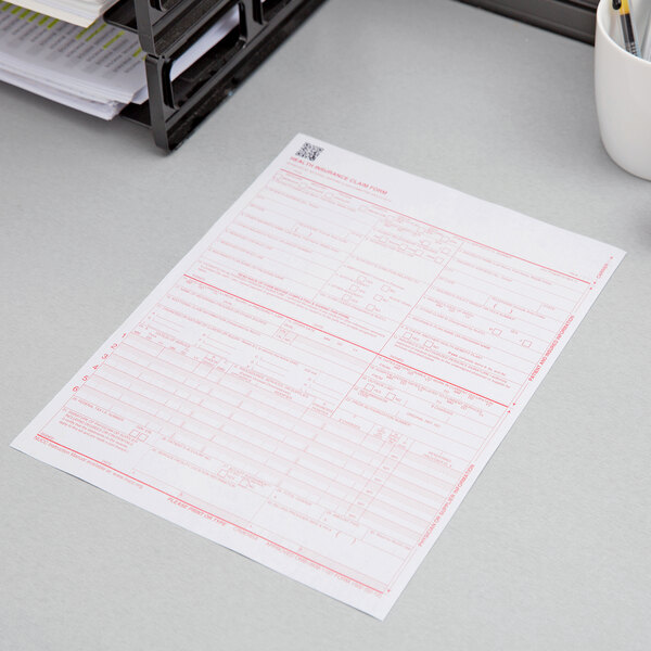 A stack of CMS-1500 forms on a table.