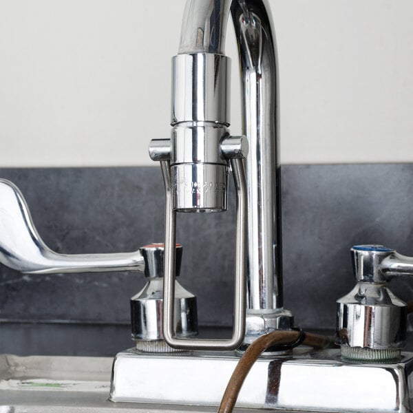 A Regency hands-free faucet wand attached to a kitchen faucet.