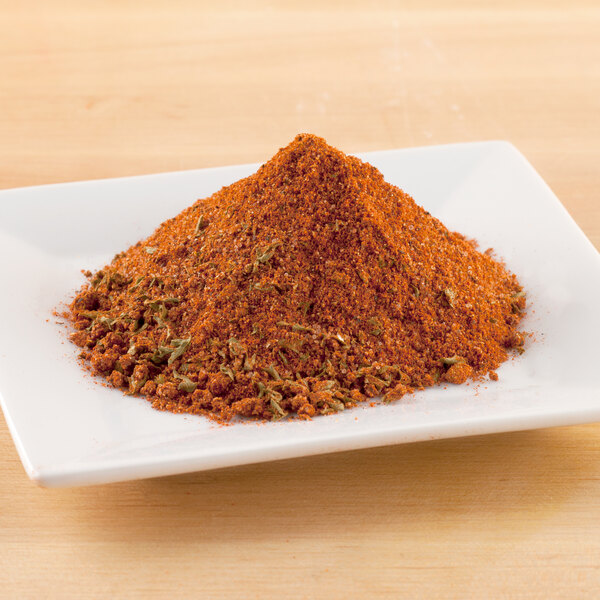 A white plate with a pile of red powder on it.