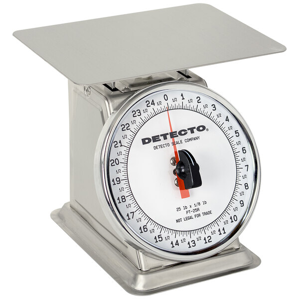 A close-up of a Cardinal Detecto stainless steel portion scale with a rotating dial.