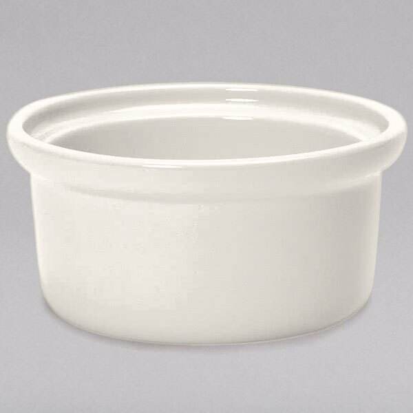 A Tuxton eggshell china bowl with a rim.