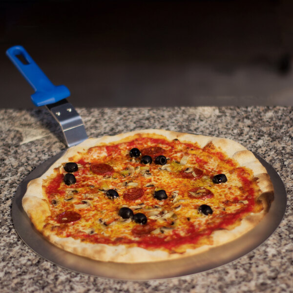 A pizza with olives and pepperoni on a GI Metal pizza tray with a polymer handle.
