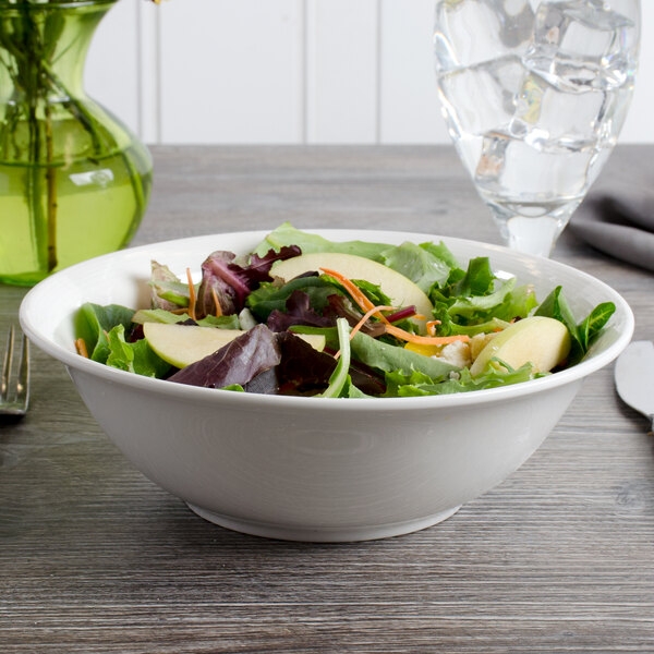 A white porcelain bowl filled with a vegetable salad.