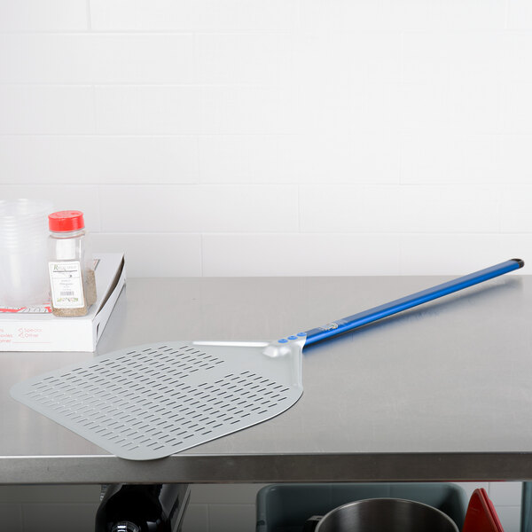 A GI Metal square pizza peel with a white handle on a counter.