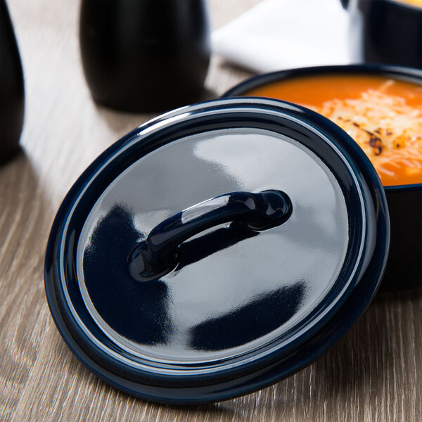 A cobalt blue Bon Chef oval lid on a bowl of soup.