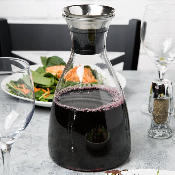 A GET Silhouette glass decanter with a red liquid in it.
