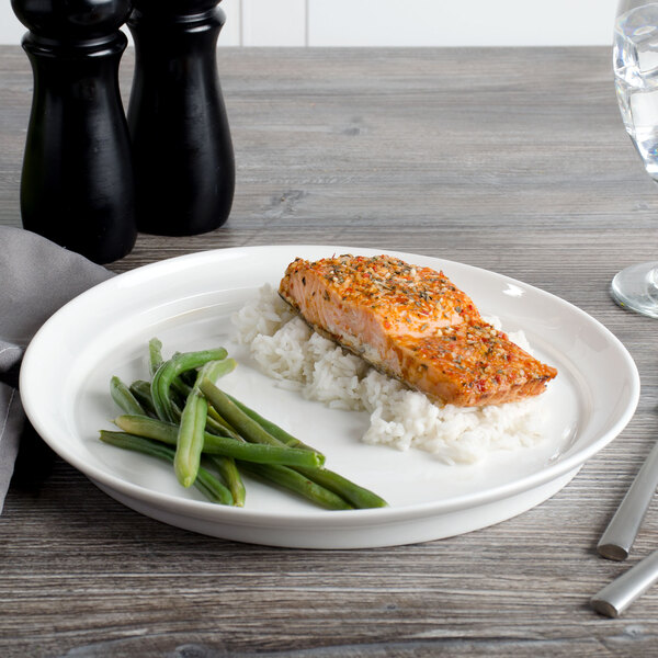 A Bon Chef white porcelain plate with a piece of salmon and rice on it.