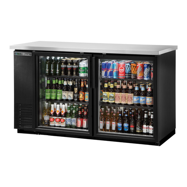 A black True back bar refrigerator with glass doors filled with beverages.