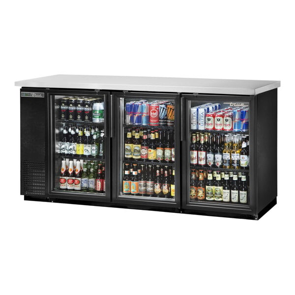 A True black narrow glass door back bar refrigerator full of beer and cans.