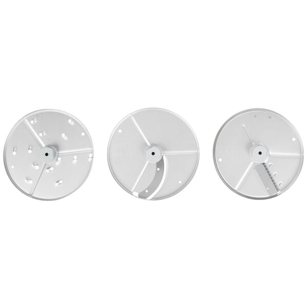 A group of three circular white Robot Coupe food processor discs with holes.