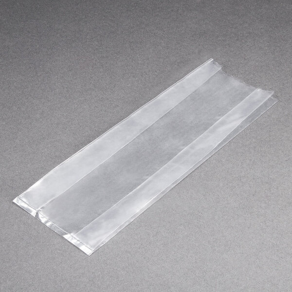 A clear plastic LK Packaging food bag on a grey surface.