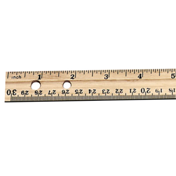 A close-up of a Charles Leonard wooden ruler with metal edge.