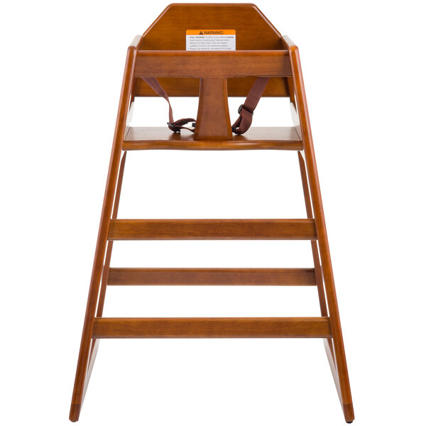 A Tablecraft hardwood high chair with a walnut finish and a strap.