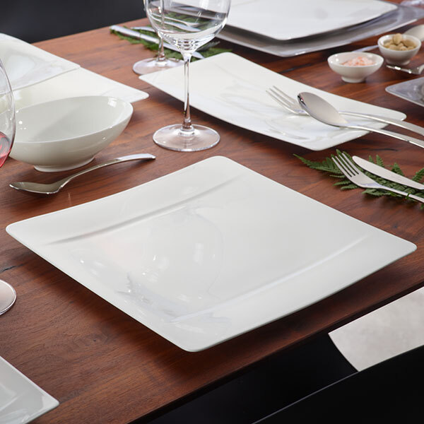 A table set with Villeroy & Boch white bone porcelain square plates and glasses.
