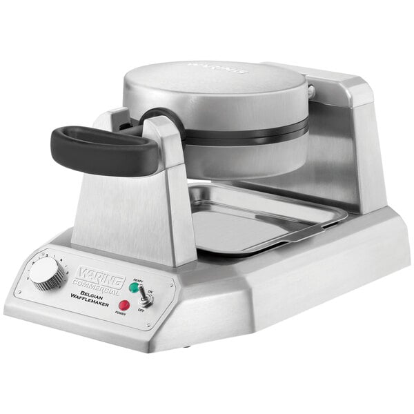 A Waring single Belgian waffle maker on a counter with a lid closed.