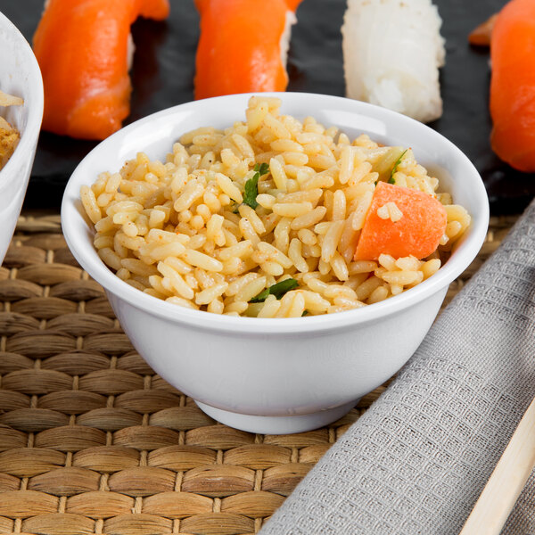 A white Thunder Group melamine rice bowl filled with rice and carrots.